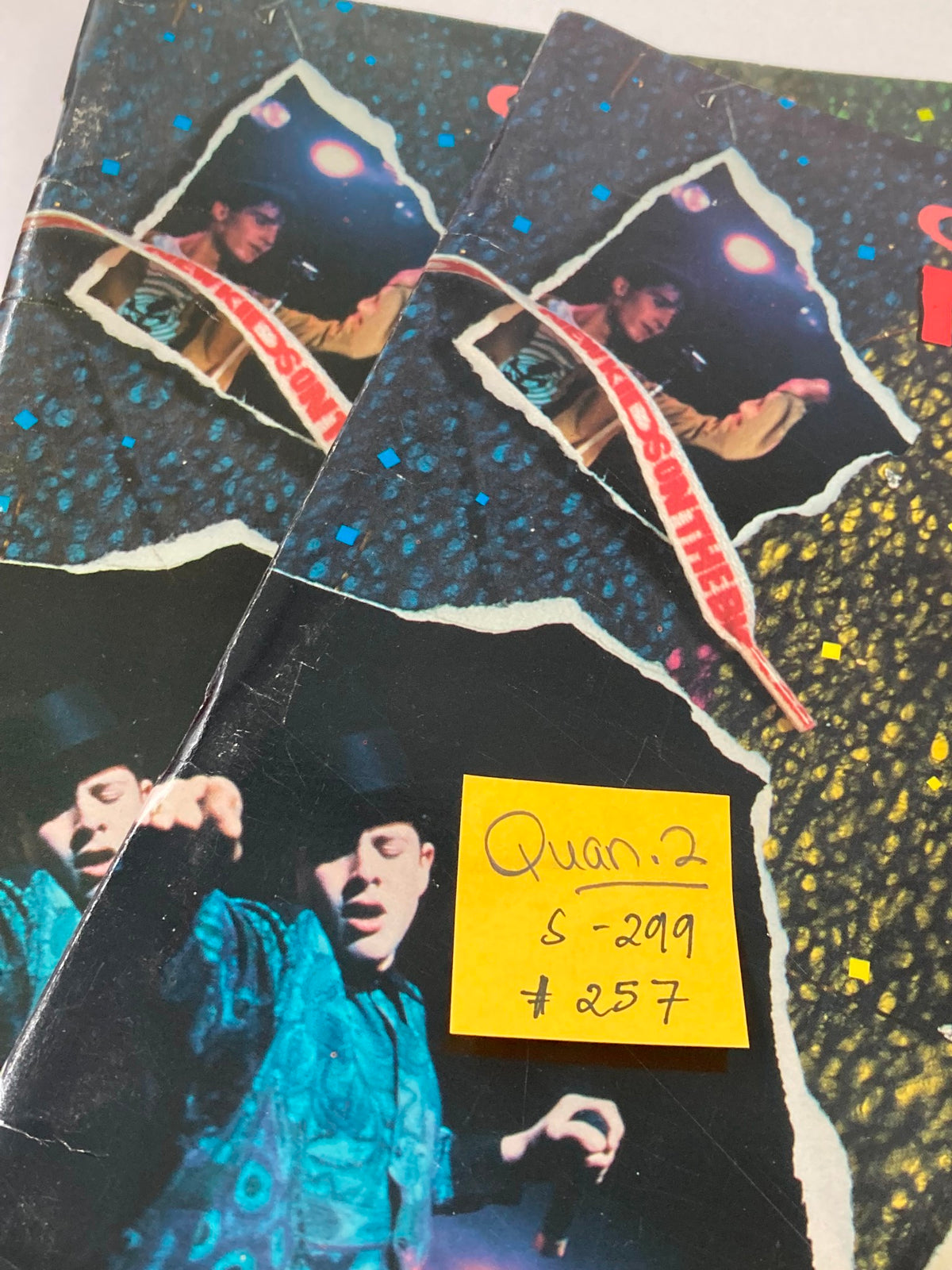 Inside page of the 1989 Official New Kids on The Block Bonus Scrapbook displaying concert imagery and handwritten notes, emphasizing the band's memorabilia.