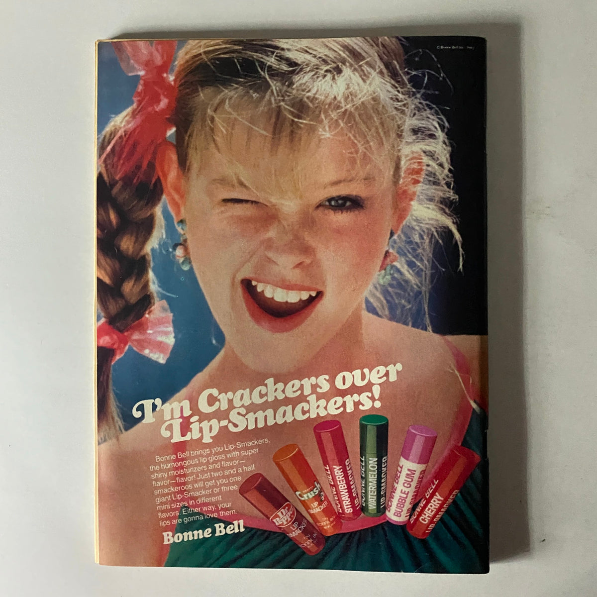 Colorful advertisement in Tiger Beat Magazine June 1982 for Bonne Bell Lip Smackers, featuring a cheerful girl modeling the product with fun lip gloss options, appealing to the youth of the era.