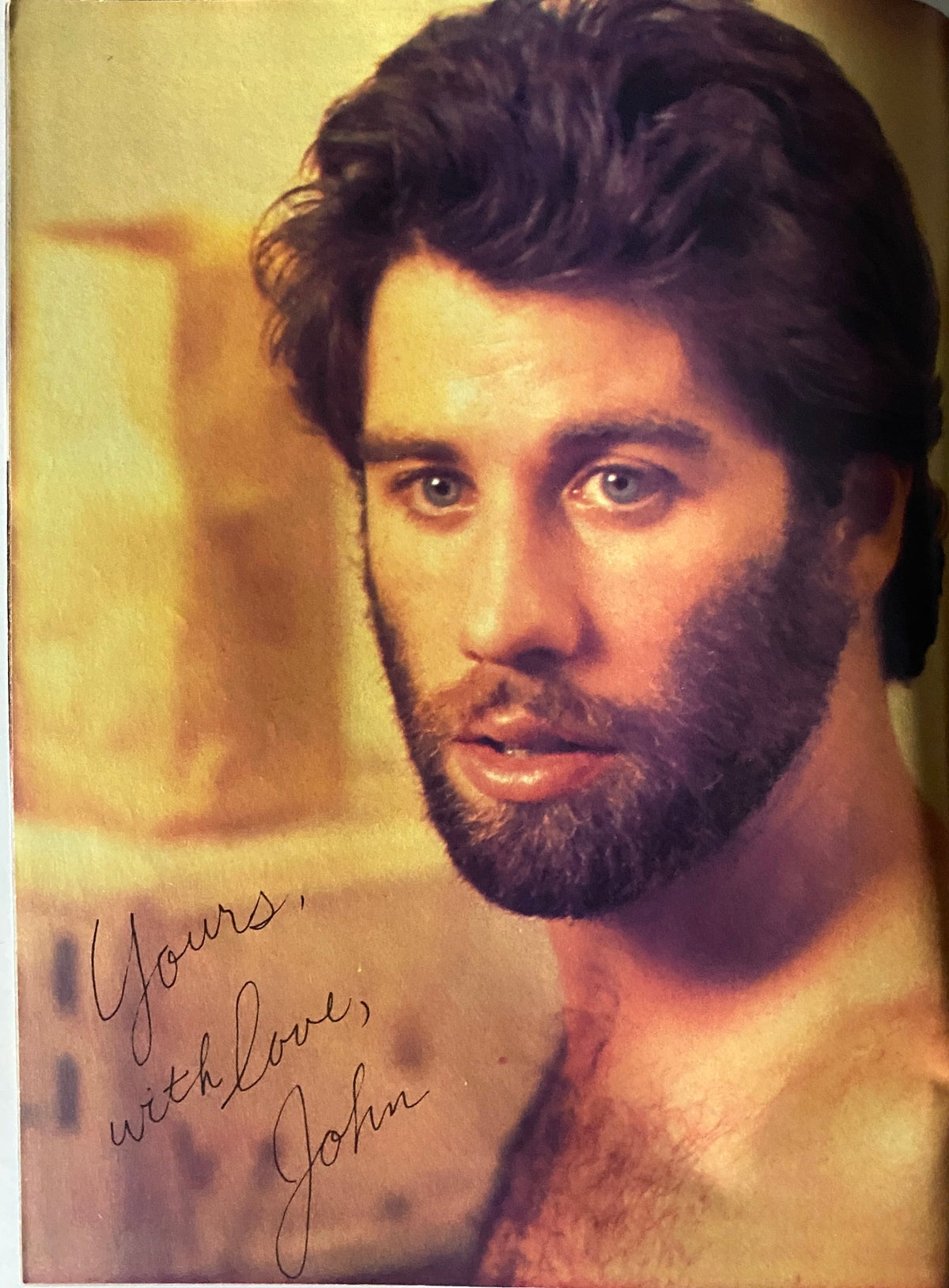 Portrait of John Travolta from the August 1980 issue of Tiger Beat Magazine, showcasing his signature look with a beard and heartfelt inscription 'Yours, with love, John.' Perfect for fans of classic 1980s pop culture.