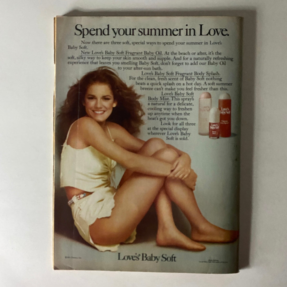 Love's Baby Soft advertisement showcasing a young woman in a playful summer outfit promoting Baby Soft fragrance products with a focus on summer freshness.
