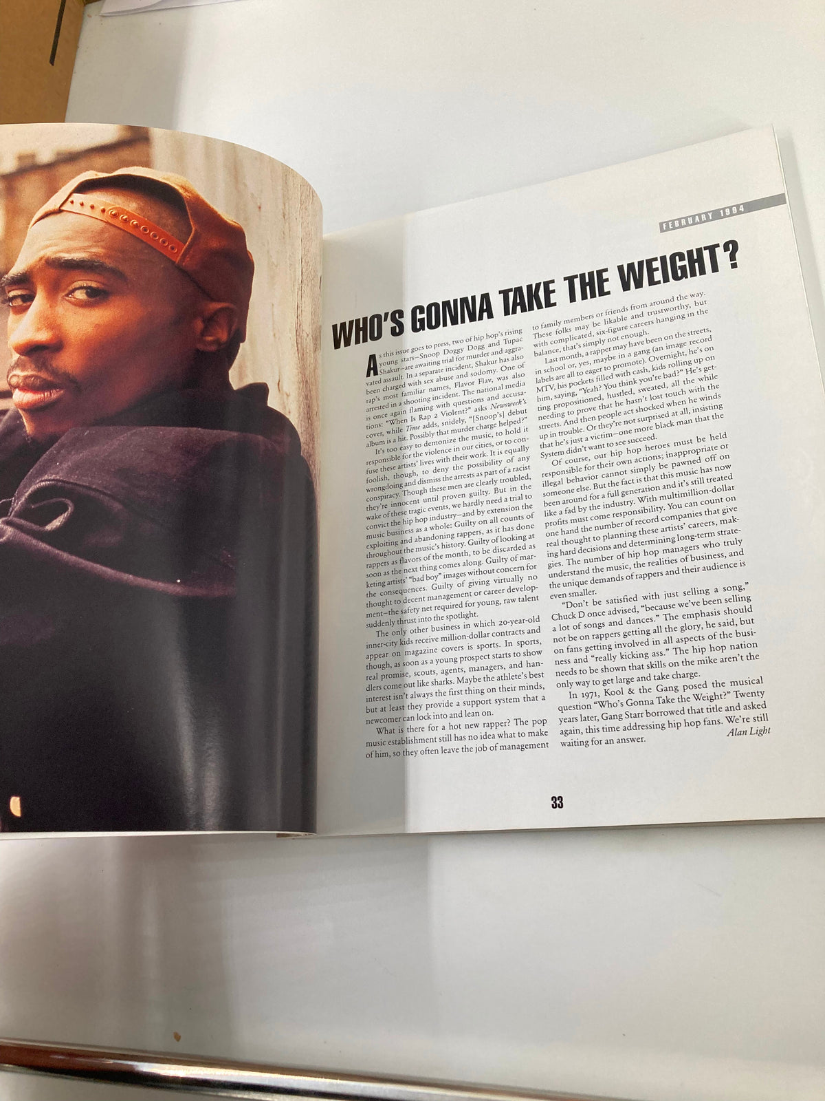 A page depicting an article titled 'WHO'S GONNA TAKE THE WEIGHT?' from 'The New York Times Best Seller Memoir of Tupac Shakur 1971 - 1996', analyzing societal challenges faced by Tupac.