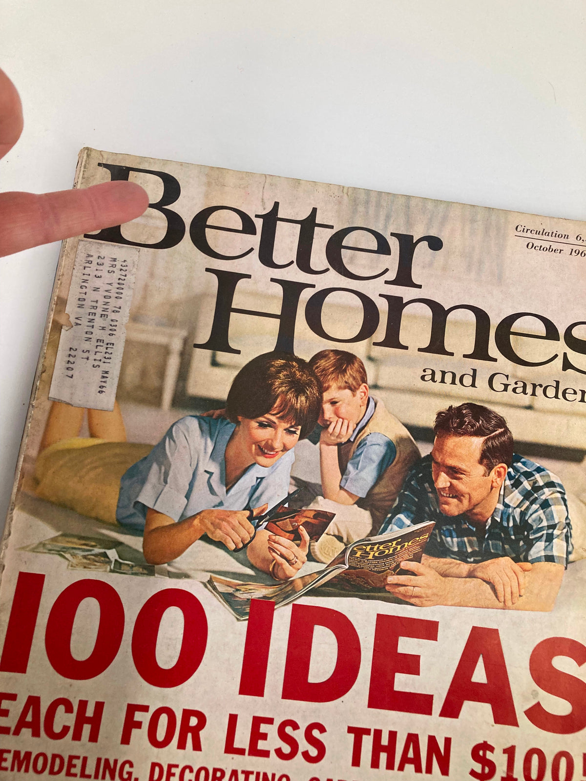 Close-up view of the cover of VTG Better Homes & Gardens Magazine October 1965 highlighting the title and a finger pointing to the text, emphasizing family finance advice.