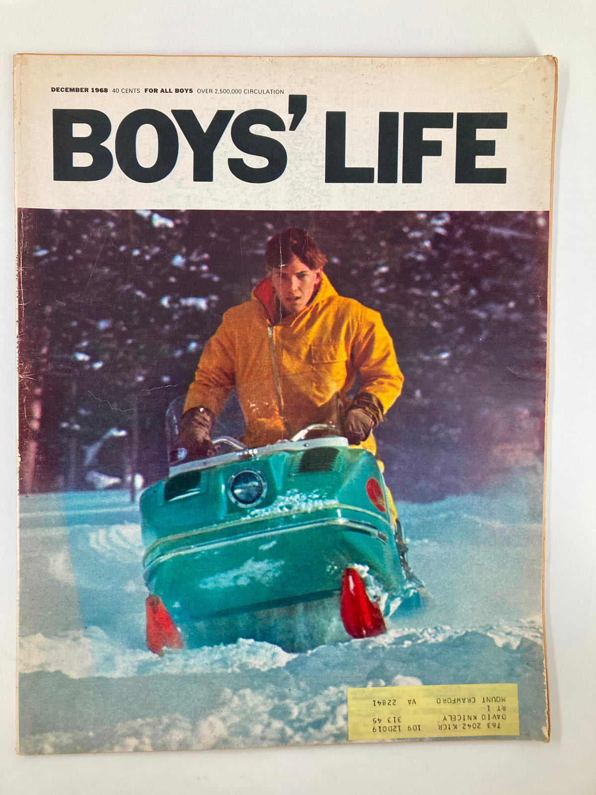 Cover of the VTG Boys' Life Magazine December 1968 featuring a boy in a yellow jacket on a green snowmobile in a snowy landscape. This vintage issue includes stories and adventures for boys.