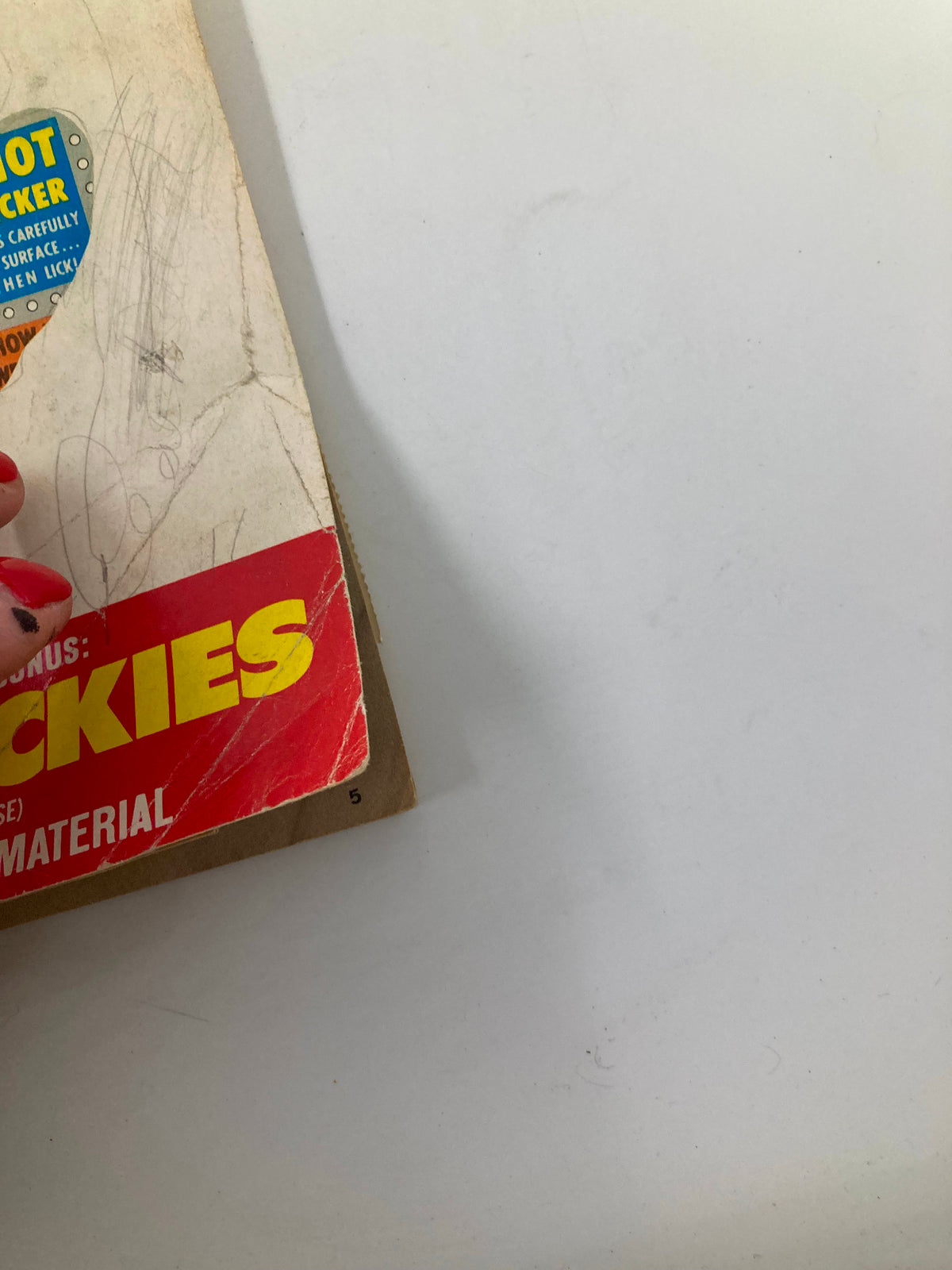 Detailed angle of Mad Magazine No. 13, illustrating the aged cover with highlighted text 'SICKIE-STICKIES' and showcasing the playful, vintage design from 1974.