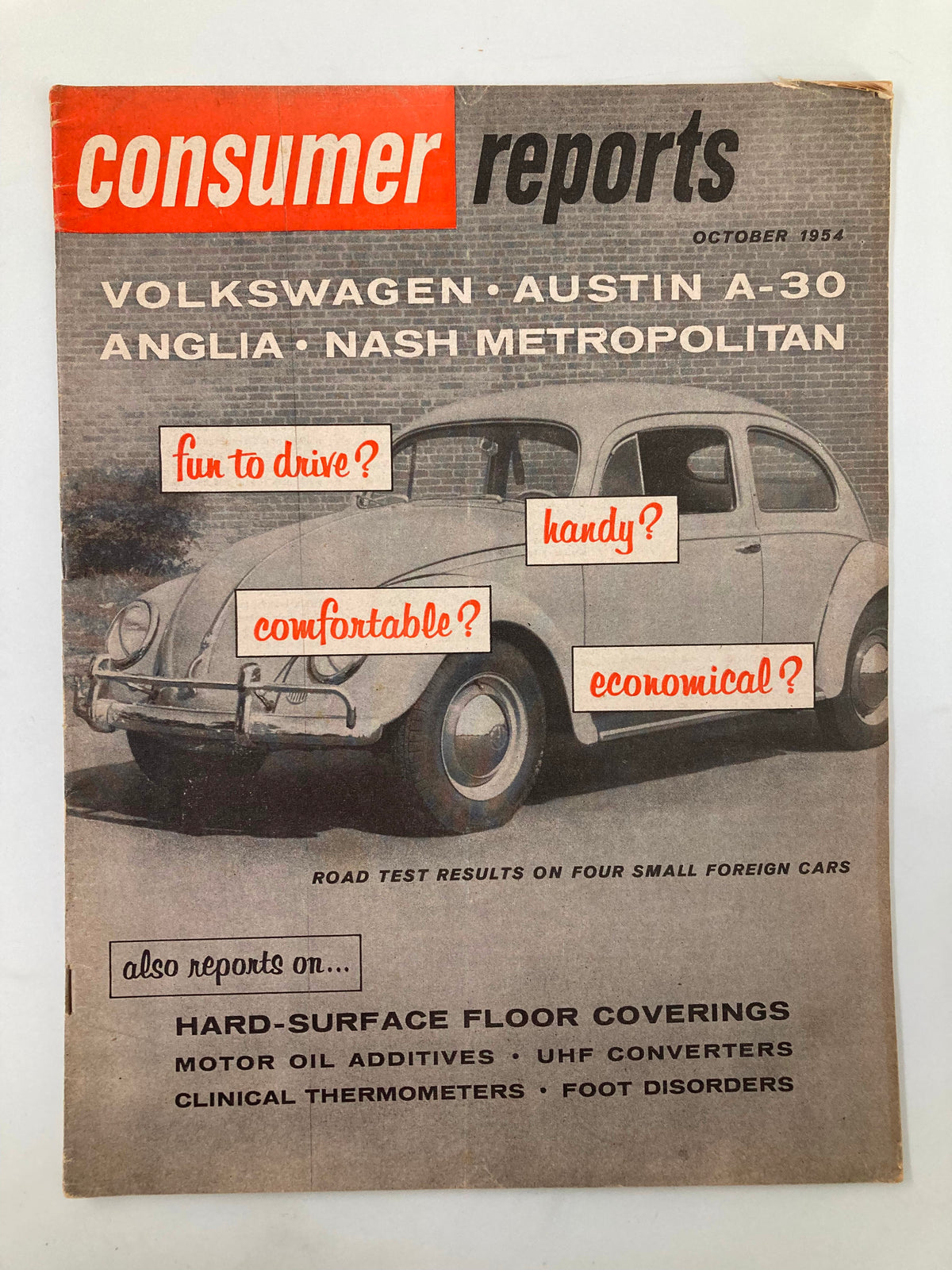 Cover of VTG Consumer Reports Magazine October 1954 featuring articles on hard-surface floor coverings, Volkswagen, Austin A-30, Anglia, and Nash Metropolitan, with highlighted consumer queries.