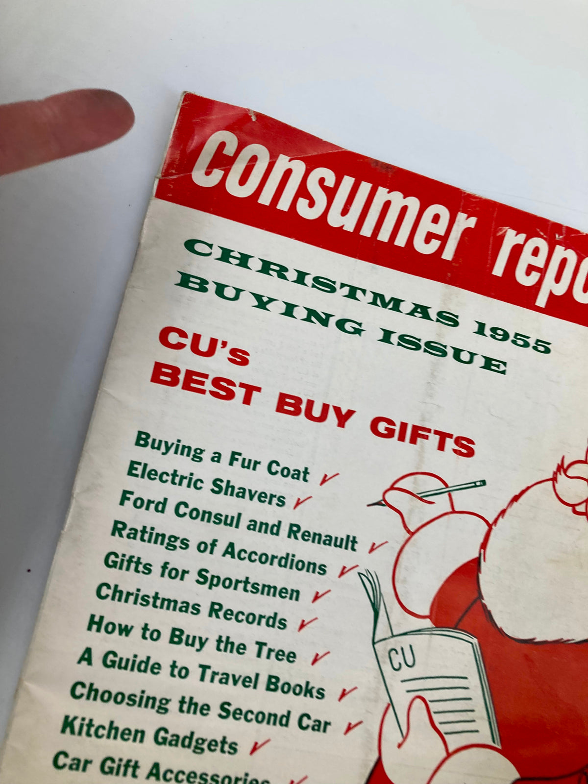 Close-up of the VTG Consumer Reports Magazine 1955 CU's Best Buy Gifts Guide cover, highlighting gift categories such as kitchen gadgets and car accessories with Santa Claus illustration.