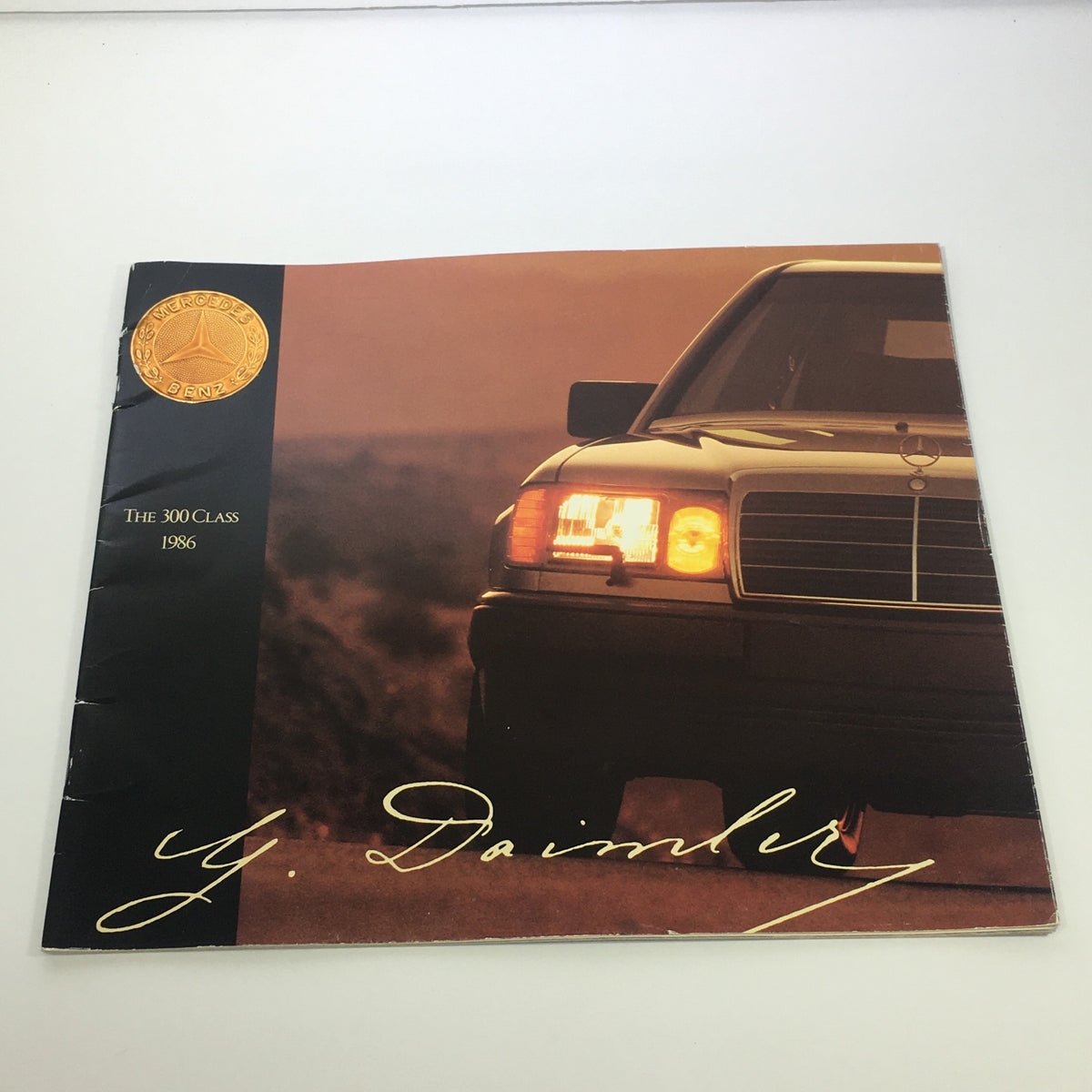 1986 Mercedes-Benz 300 Class w/Logo Seal Dealership Car Auto Brochure Catalog cover featuring the iconic Mercedes-Benz logo and a stylish vehicle in a scenic backdrop.