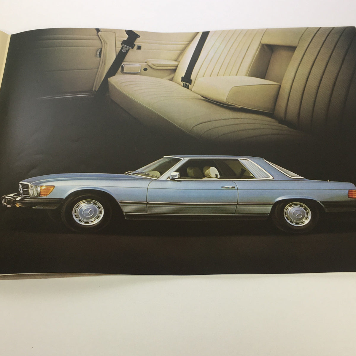 Side view of a 1970s Mercedes-Benz 450SL showcasing the interior design, as featured in the 1970s Mercedes-Benz 280SE 450SEL 450SL Dealership Car Auto Brochure Catalog.