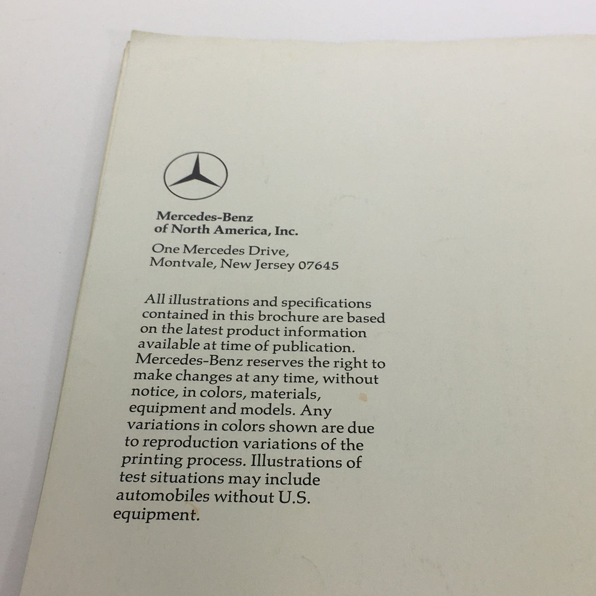 Close-up of the back cover of the 1970s Mercedes-Benz 280SE 450SEL 450SL Dealership Car Auto Brochure Catalog, featuring Mercedes-Benz branding and contact information.