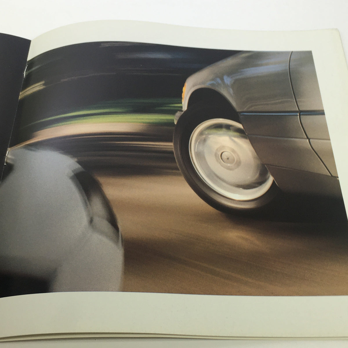 Dynamic image from the 1996 Mercedes-Benz E-Class SL-Class C-Class Dealership Car Auto Brochure Catalog capturing a Mercedes-Benz in motion, highlighting its speed.