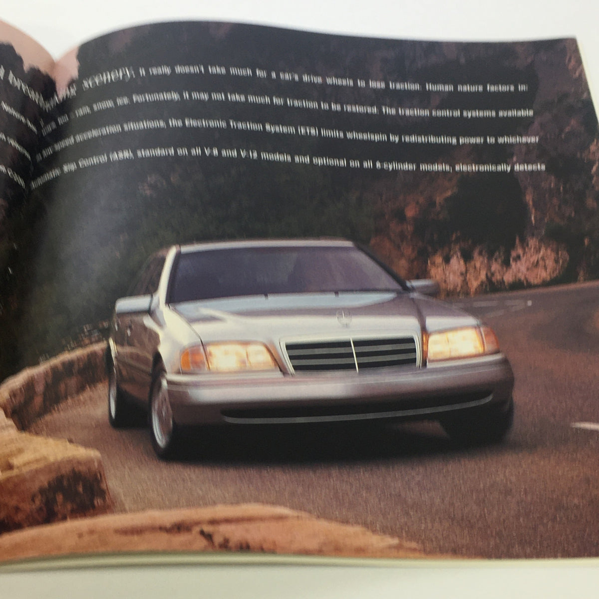 Page from the 1996 Mercedes-Benz E-Class SL-Class C-Class Dealership Car Auto Brochure Catalog featuring a silver Mercedes-Benz car on a winding road, illustrating its performance.