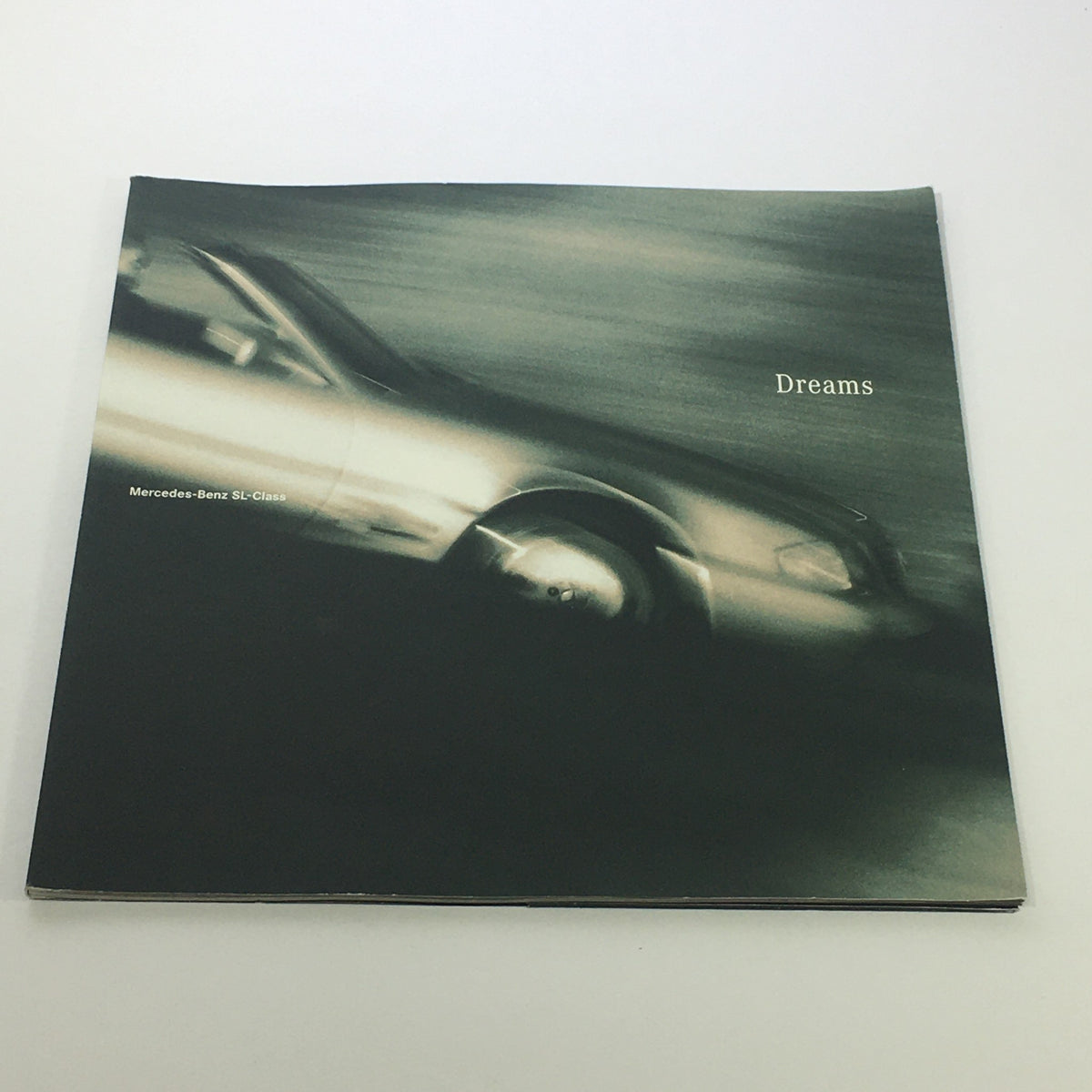Cover page of the 1996 Mercedes-Benz Dreams SL-Class Dealership Car Auto Brochure Catalog, featuring a blurred image of a Mercedes-Benz SL-Class driving in motion.