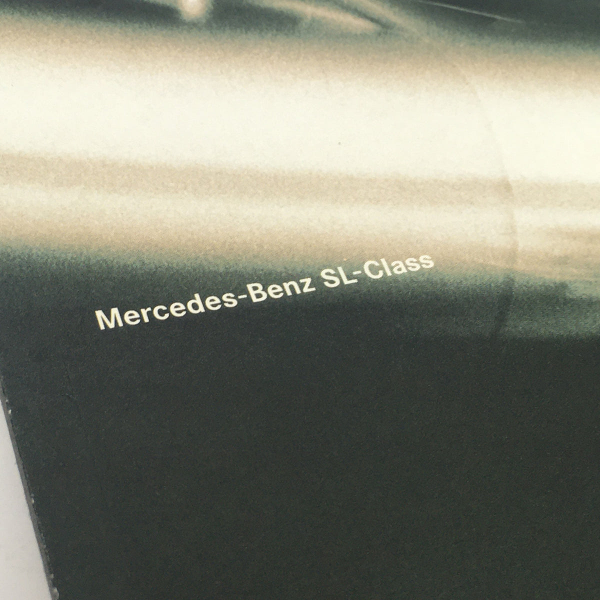Close-up of the text on the 1996 Mercedes-Benz Dreams SL-Class Dealership Car Auto Brochure Catalog, showcasing the brand name Mercedes-Benz SL-Class.