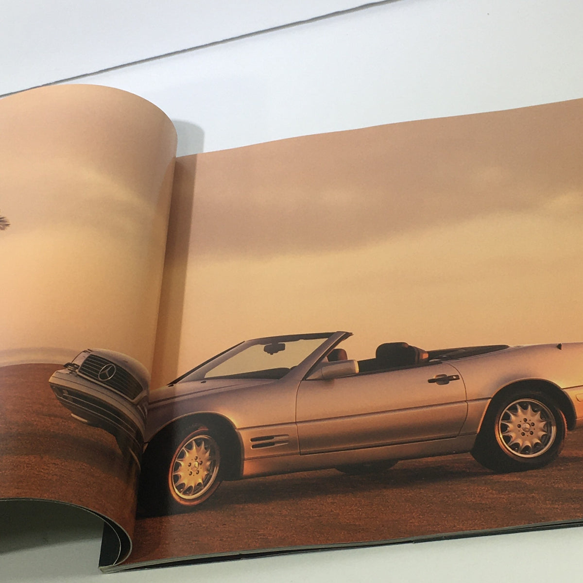 Full page inside the 1996 Mercedes-Benz Dreams SL-Class Dealership Car Auto Brochure Catalog displaying a silver Mercedes SL-Class convertible against a sunset backdrop.