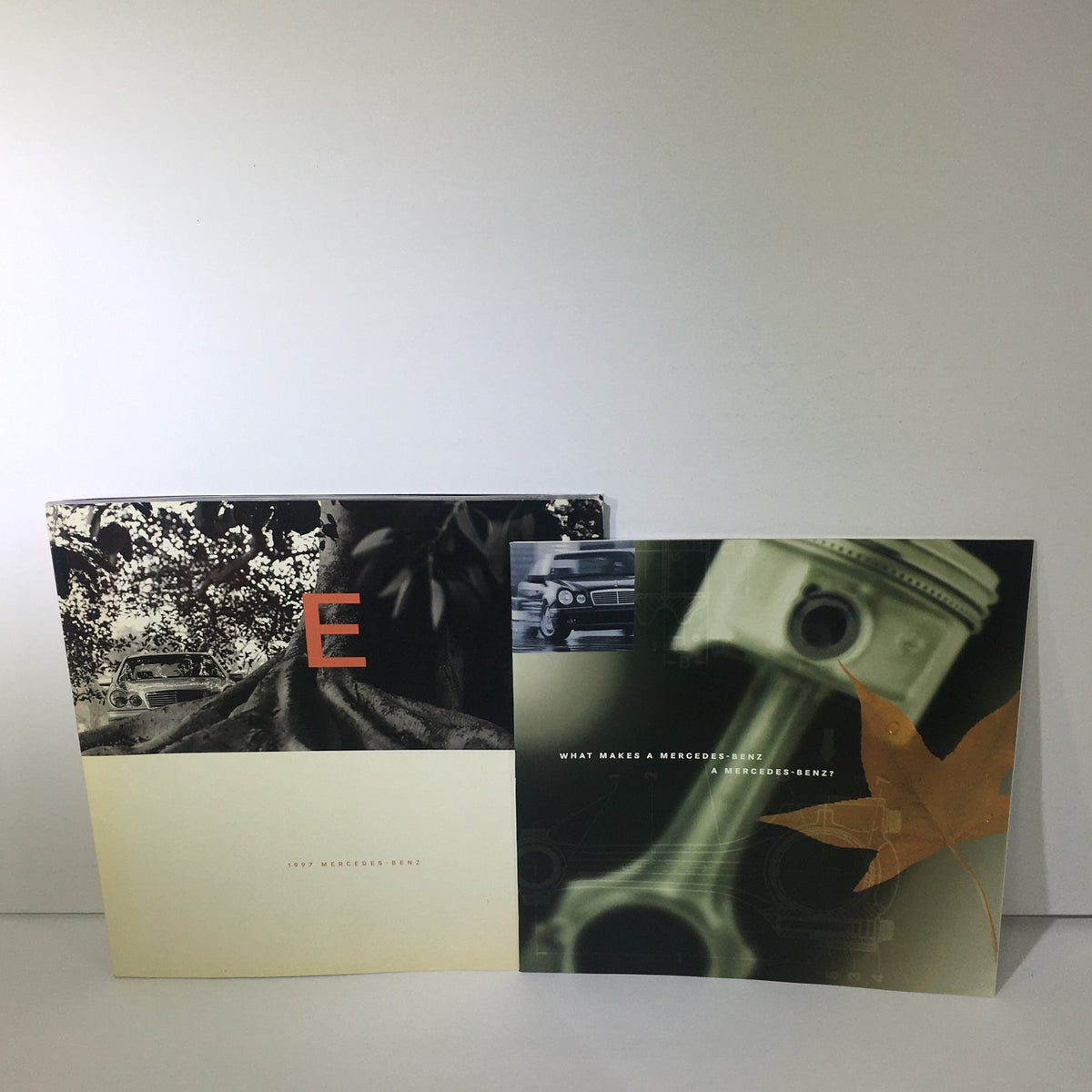 1997 Mercedes-Benz E-Class Dealership Car Auto Brochure Catalog featuring an artistic cover with the letter 'E' and a tree backdrop.