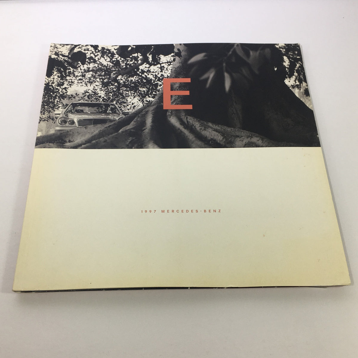 1997 Mercedes-Benz E-Class Dealership Car Auto Brochure Catalog showcasing the front cover with a tree and the letter 'E' prominently displayed.