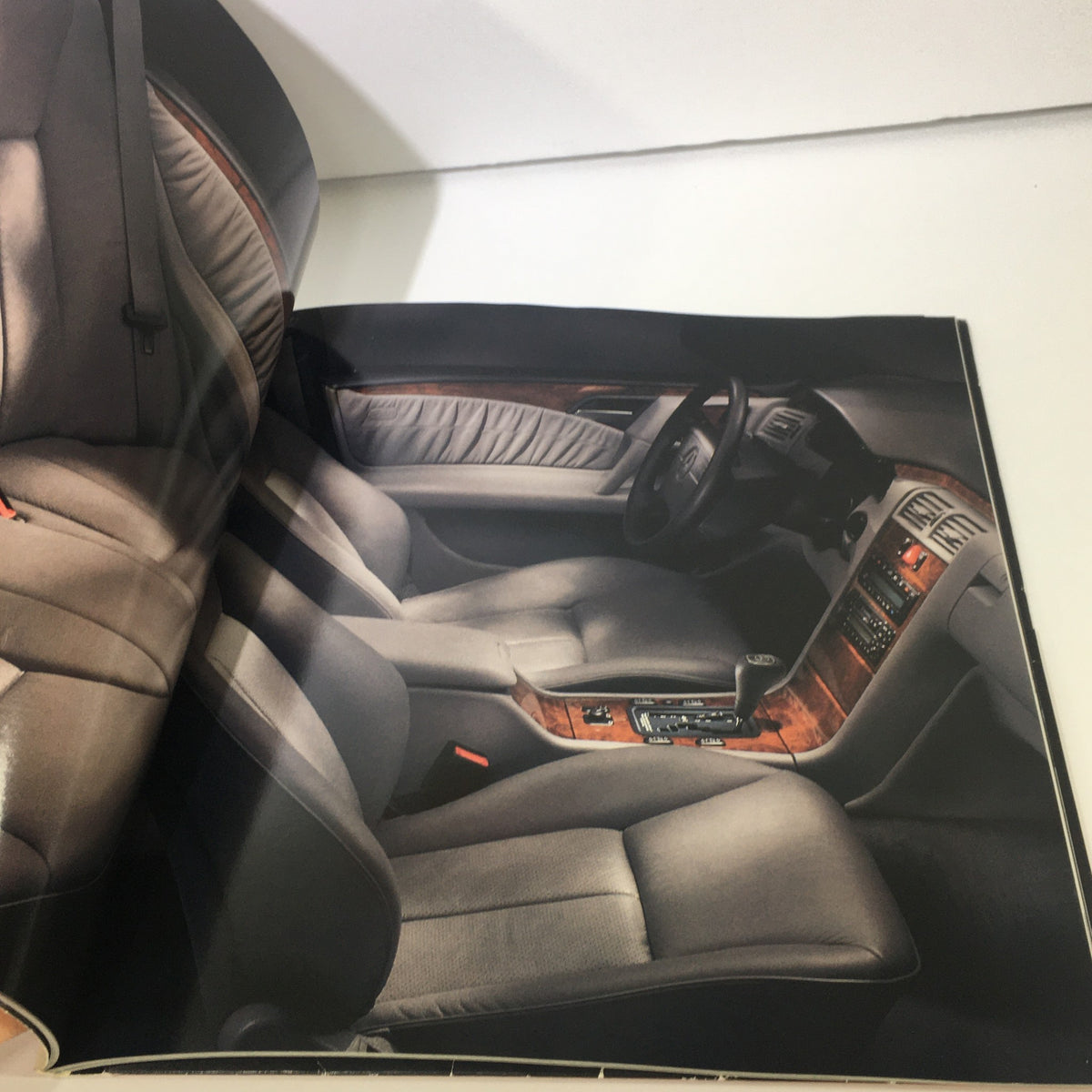 Interior view of the 1997 Mercedes-Benz E-Class showcasing leather seats and dashboard in the dealership brochure.