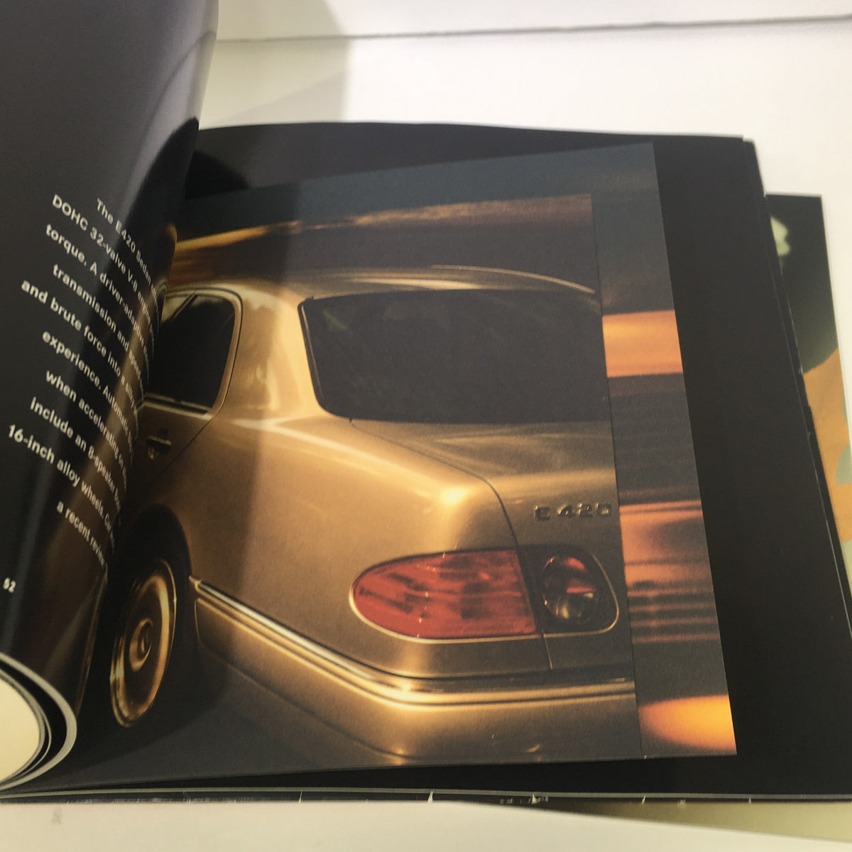 Close-up of the back of the 1997 Mercedes-Benz E-Class showcasing the rear design featured in the dealership auto brochure.