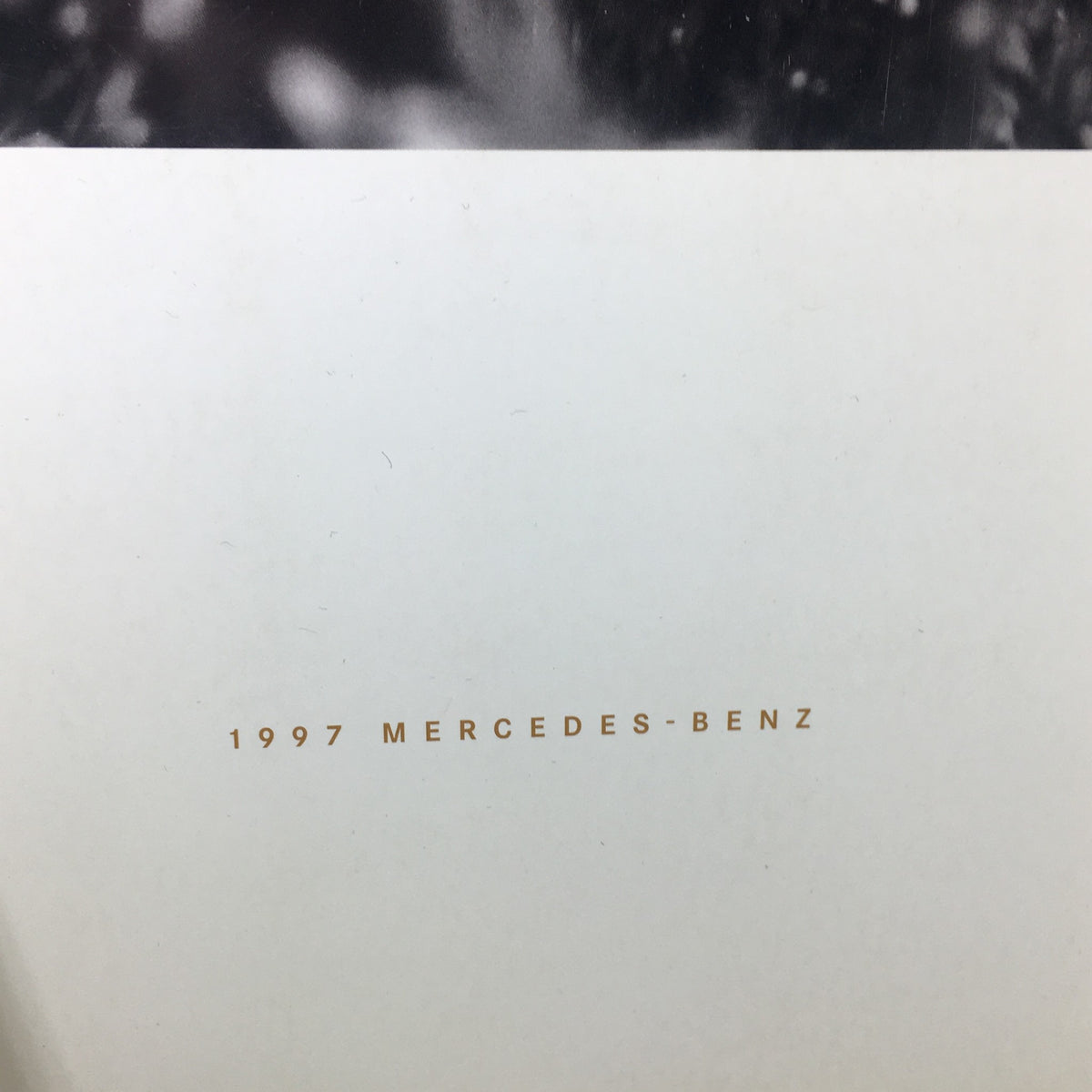 Close-up of the 1997 Mercedes-Benz SL-Class Dealership Car Auto Brochure showing detailed print stating '1997 Mercedes-Benz'.