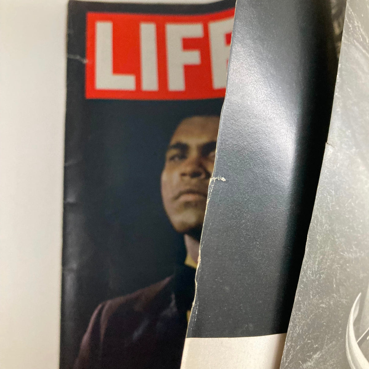 Close-up view of the vintage VTG Life Magazine from March 5, 1971 featuring Muhammad Ali in a dramatic pose, celebrating the iconic boxing match against Joe Frazier, known as the Battle of the Champs.