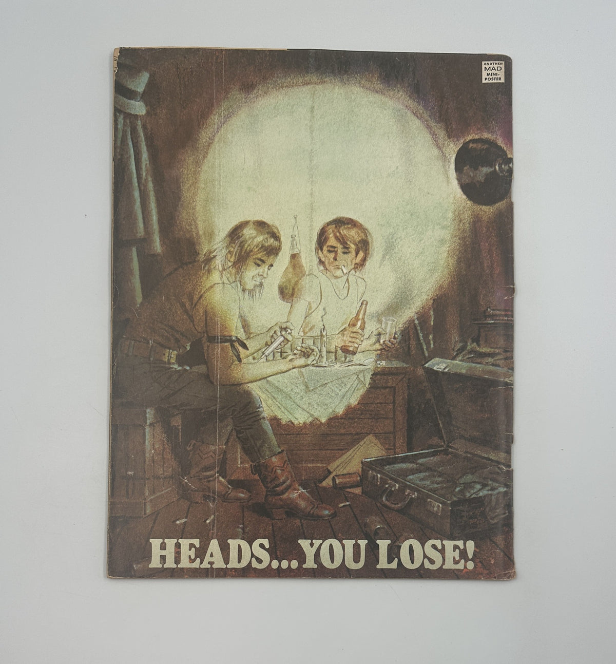 Back cover of MAD Magazine No. 165 March 1974 showcasing an artistic illustration with the words 'HEADS... YOU LOSE!' emphasizing the humorous and satirical nature of the magazine.
