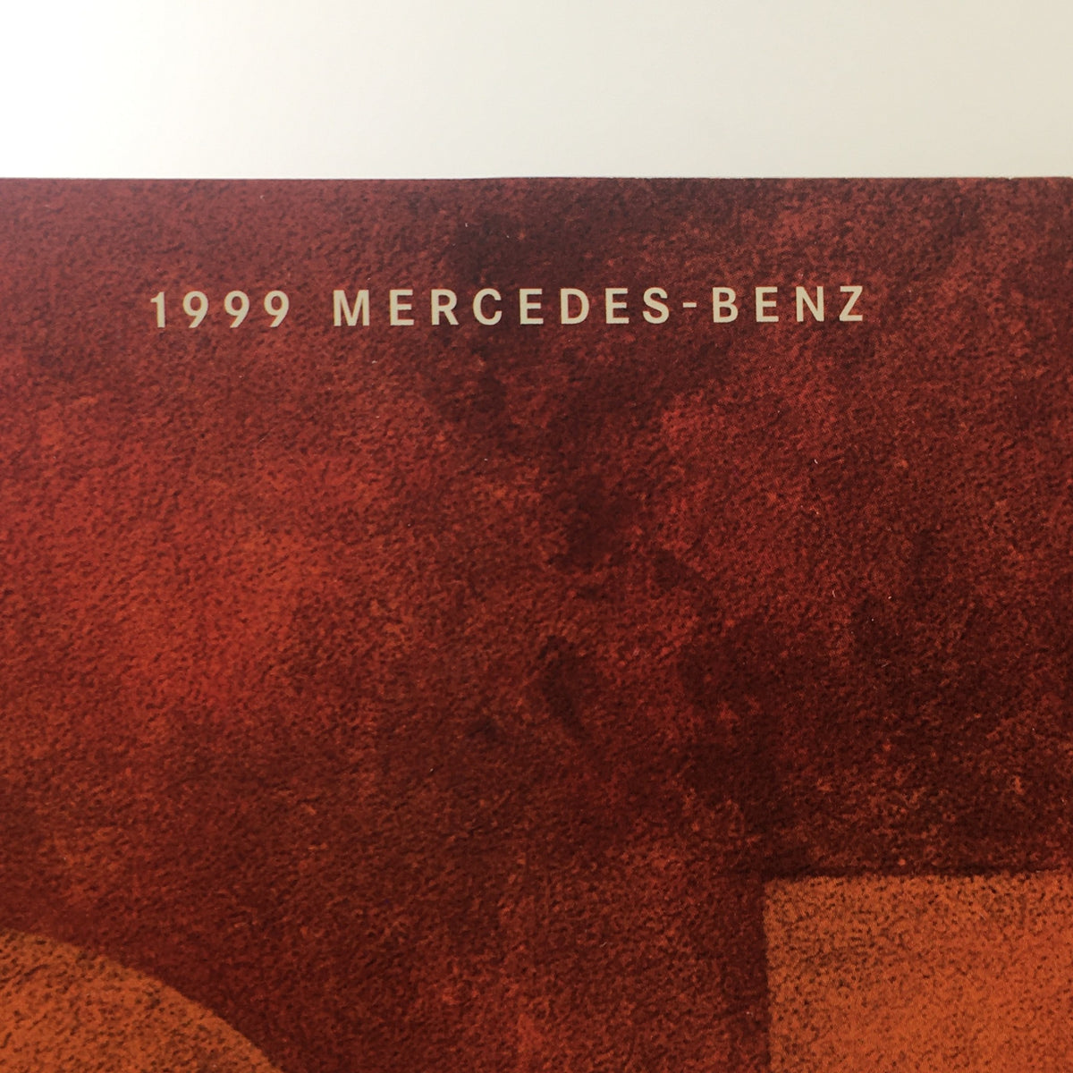 Top view of the 1999 Mercedes-Benz logo and title on the brochure cover of the 1999 Mercedes-Benz SL-Class Sport Package.