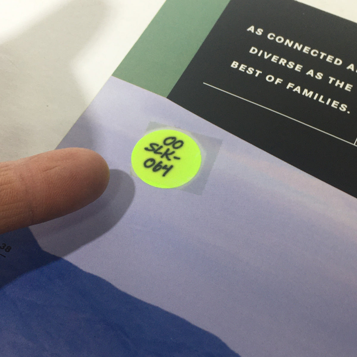 Detail of a sticker on the 2000 Mercedes-Benz SLK Designo Editions dealership car auto brochure catalog, indicating identification code for inventory.