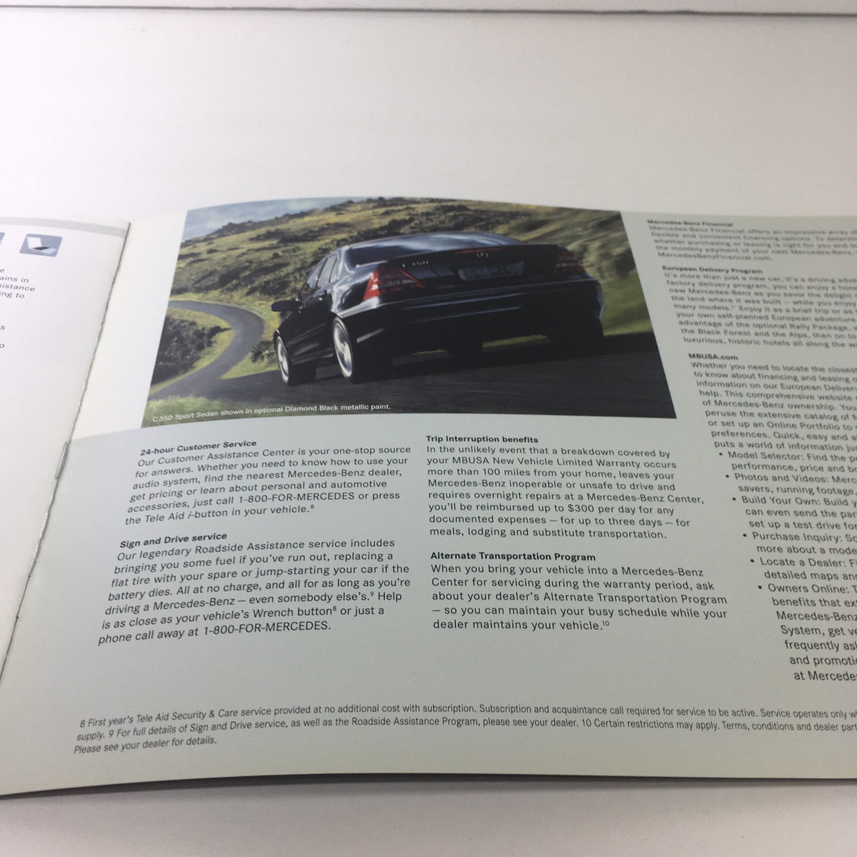 Image of the back view of a 2007 Mercedes-Benz C-Class Sports Sedan driving on a scenic road, featured in the 2007 Mercedes-Benz C-Class Sports Sedans Dealership Car Auto Brochure Catalog.