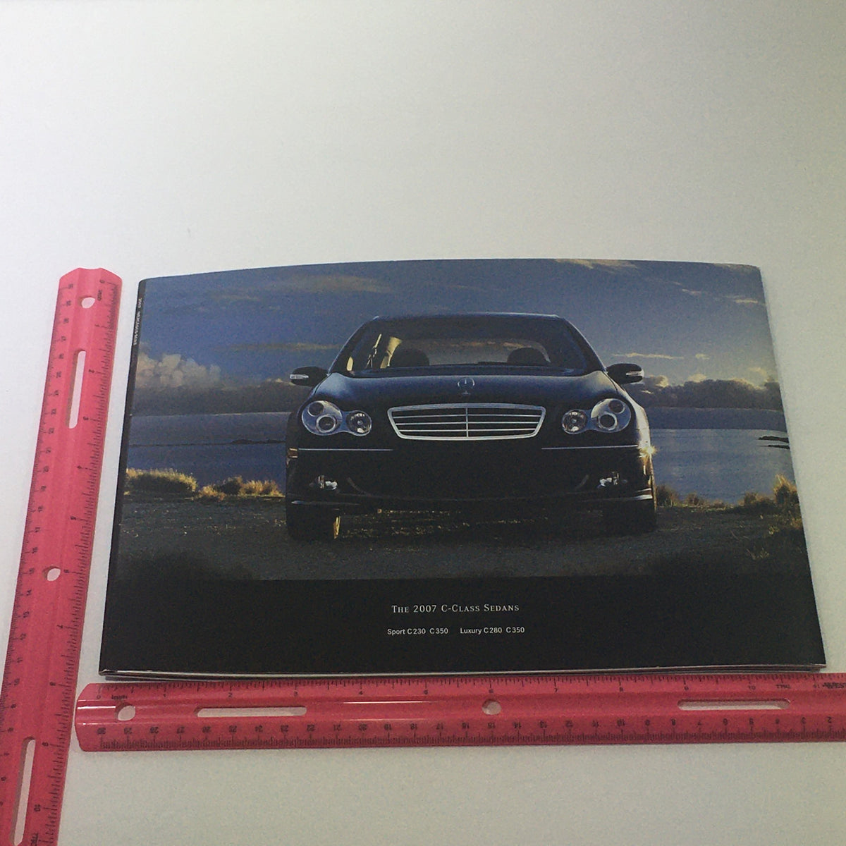 Image of the front cover of the 2007 Mercedes-Benz C-Class Sports Sedans Dealership Car Auto Brochure Catalog, highlighting a sleek black Mercedes-Benz C-Class Sedan.