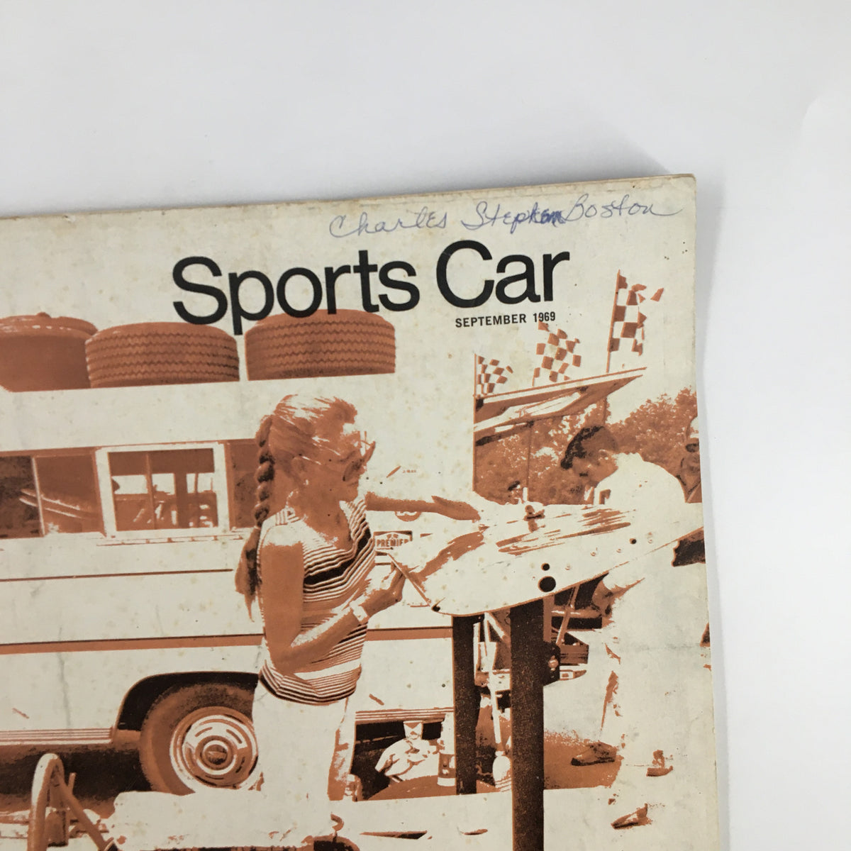 Close-up of the cover of VTG Sports Car Magazine September 1969 depicting a young girl at a racing event surrounded by vintage elements.