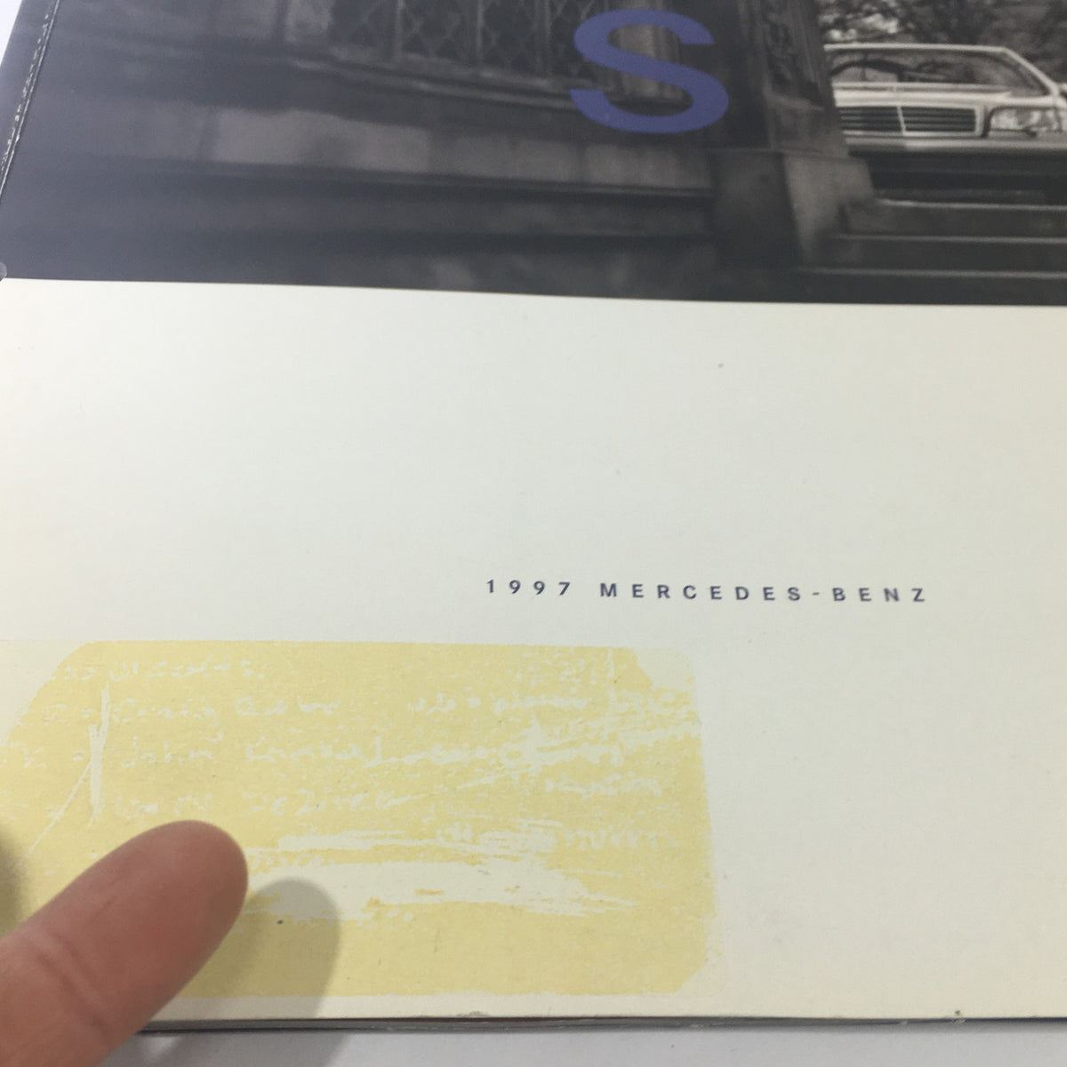 Close-up view of the 1997 Mercedes-Benz S-Class Dealership Car Auto Brochure Catalog, highlighting the title and condition.