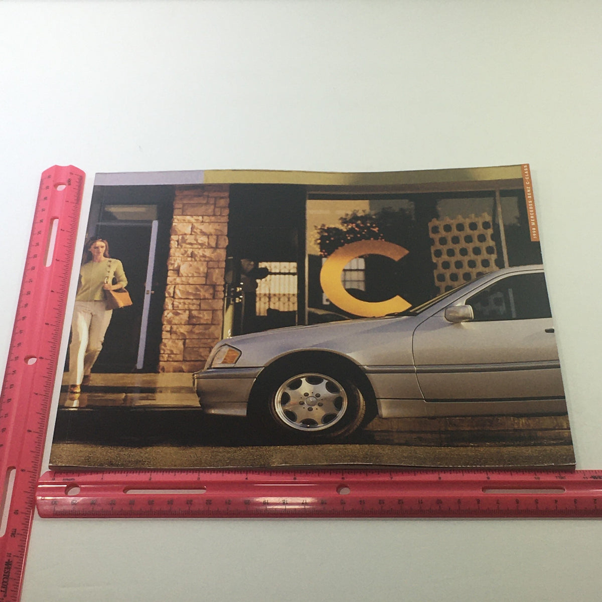 1998 Mercedes-Benz C-Class Dealership Car Auto Brochure Catalog featuring a silver Mercedes-Benz C-Class parked outside a dealership with a large letter C.
