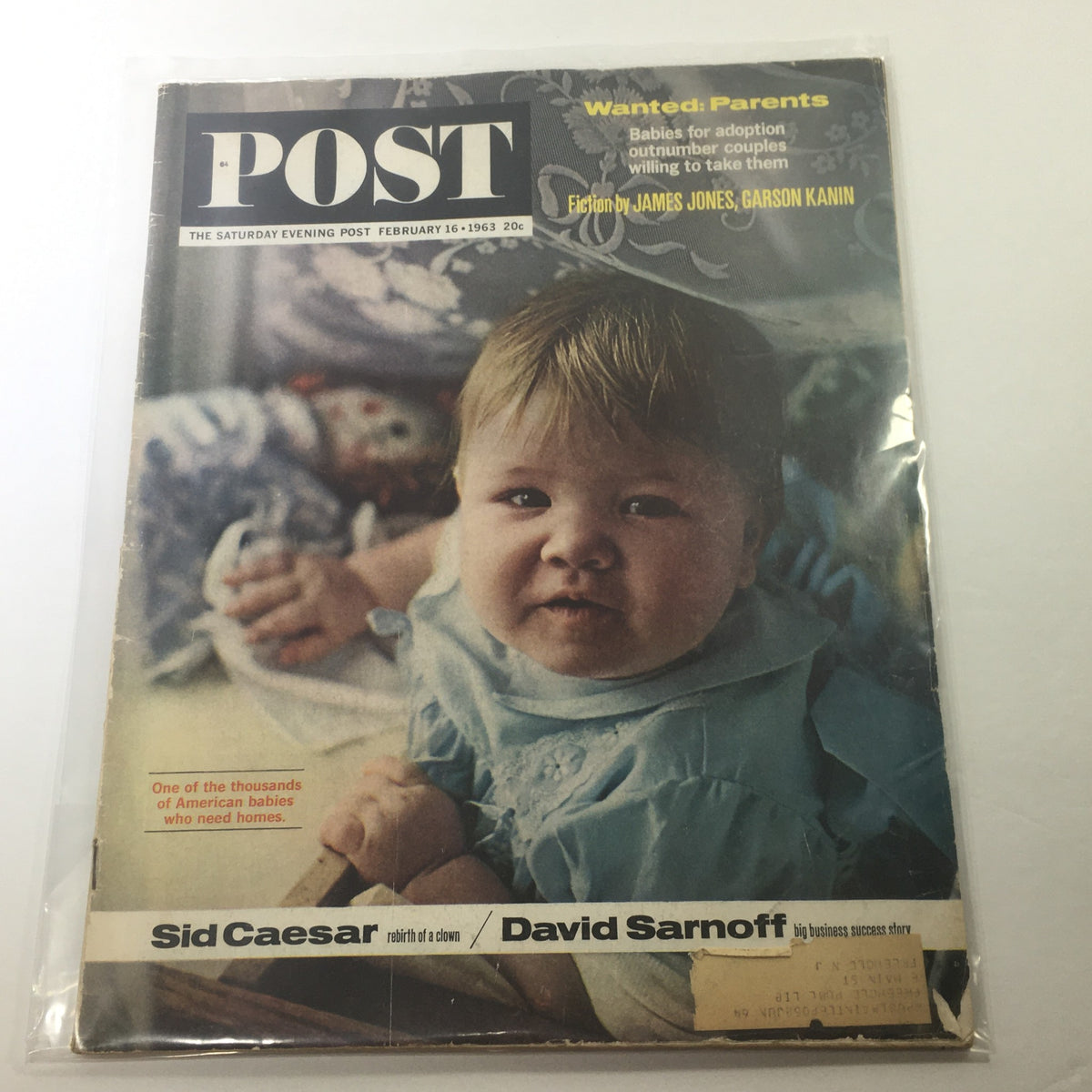 The Saturday Evening Post Magazine cover from February 16, 1963, featuring a baby for adoption, highlighting the theme 'Wanted: Parents'. This vintage magazine includes additional articles by Sid Caesar and David Sarnoff.