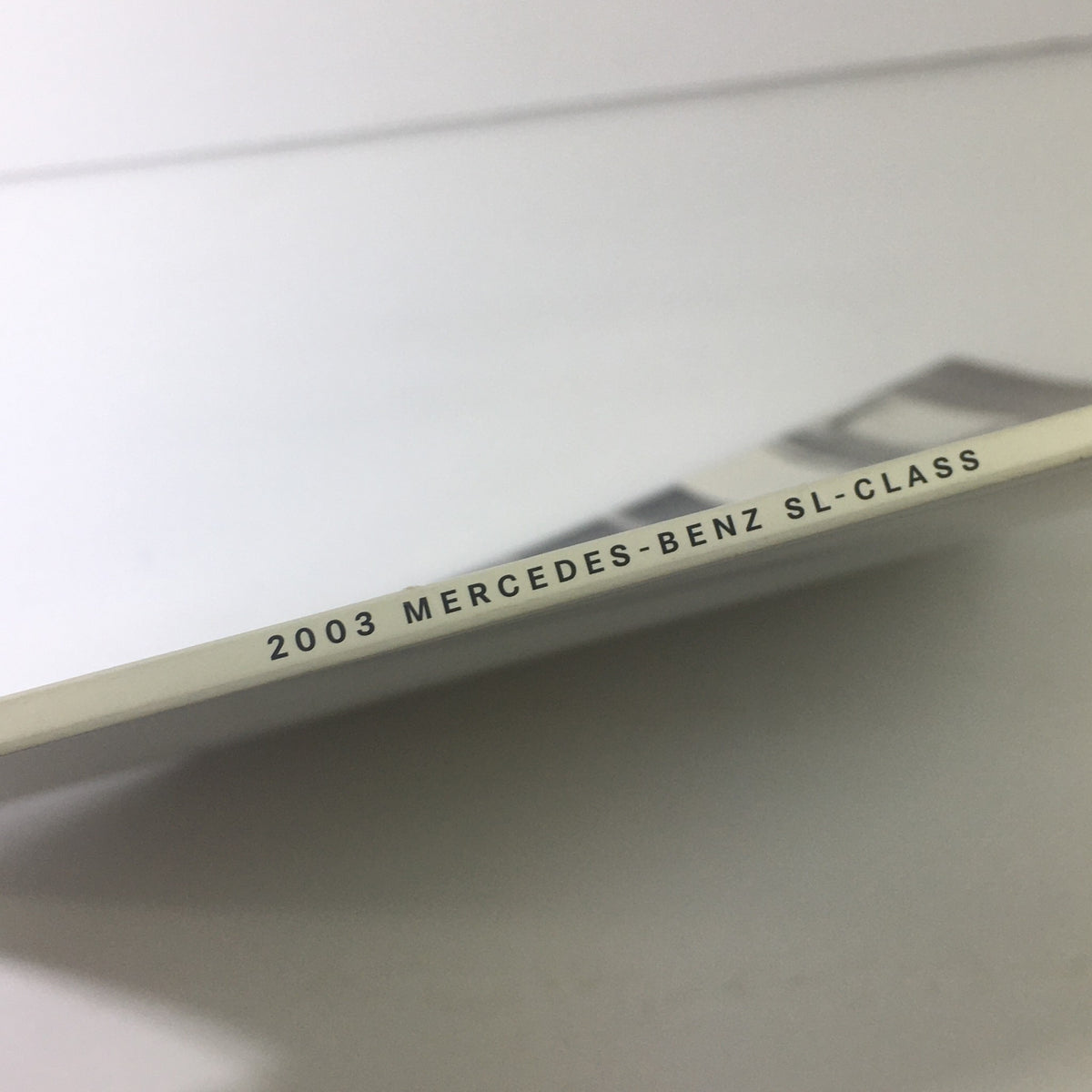 Side view of the spine detailing '2003 MERCEDES-BENZ SL-CLASS' on the catalog of the 2003 Mercedes-Benz SL-Class Dealership Car Auto Brochure.