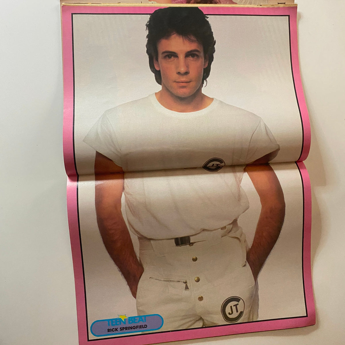 Teen Beat Magazine June 1983 showcases Rick Springfield posing confidently in a casual white t-shirt and pants. A quintessential image representing '80s teen idol culture, perfect for collectors.