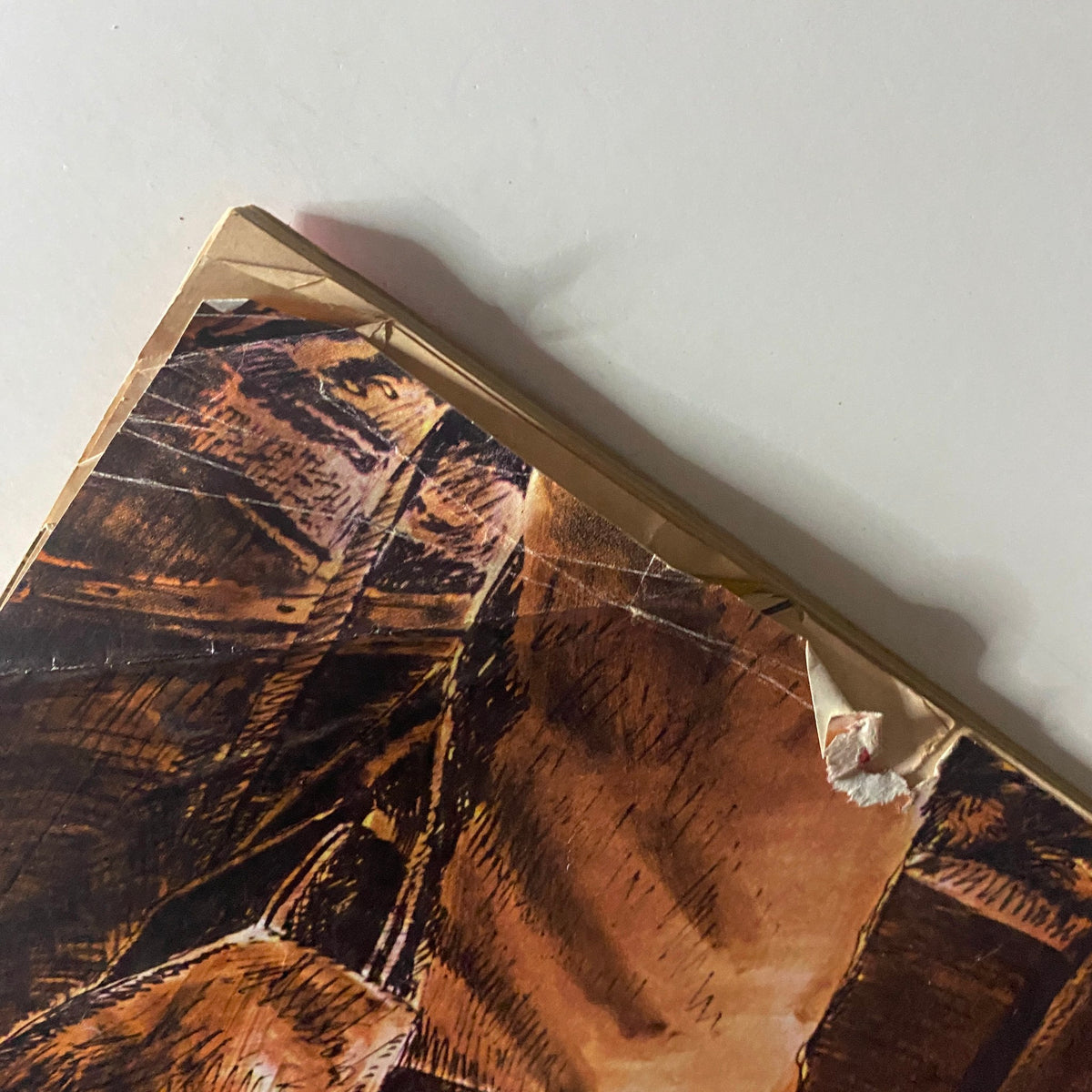 Close-up view of the damaged top corner of the back cover from Time Magazine November 27, 1964, Vol 84 No. 22, displaying wear and tear from age.