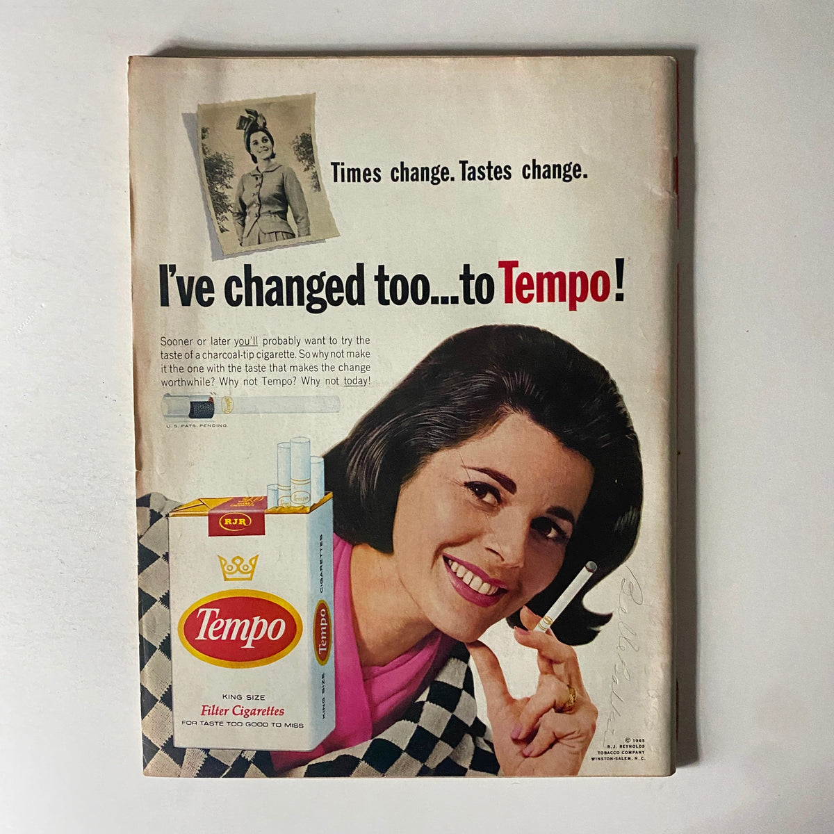 Advertisement from a vintage magazine promoting Tempo cigarettes, featuring a smiling woman with charcoal-tip cigarette packaging. This advertisement reflects cultural changes and trends in smoking habits during the 1960s.
