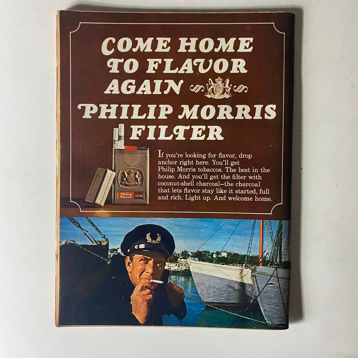 Vintage advertisement for Philip Morris Filter cigarettes with a sailor character, emphasizing flavor and quality, featured in a nostalgic magazine layout.