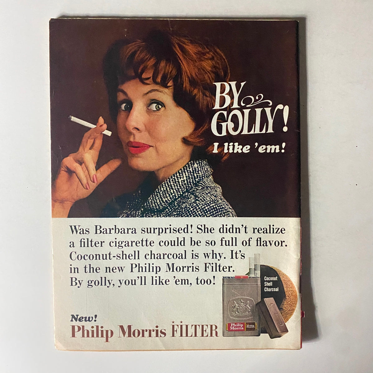 Vintage advertisement for Philip Morris filter cigarettes, featuring a woman expressing surprise at the flavor, highlighting 1960s advertising style.