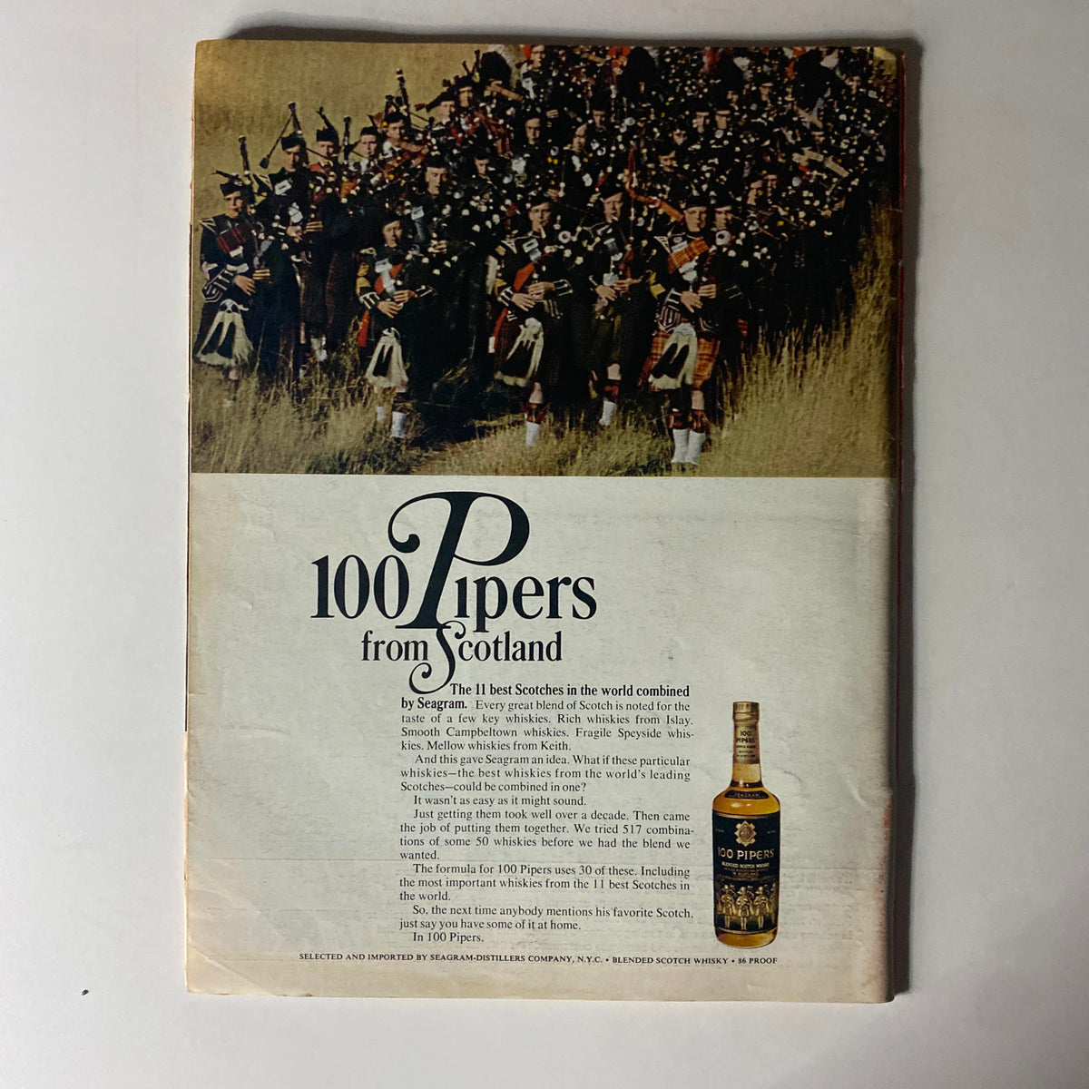 Back cover of Time Magazine from July 23, 1965, featuring an advertisement for '100 Pipers from Scotland' whiskey, highlighting Scottish heritage.