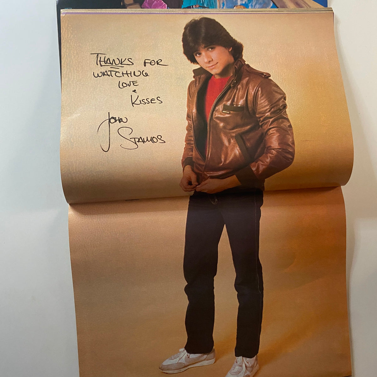 John Stamos promotional image in a leather jacket, with a signed message, from Tiger Beat Magazine August 1982.