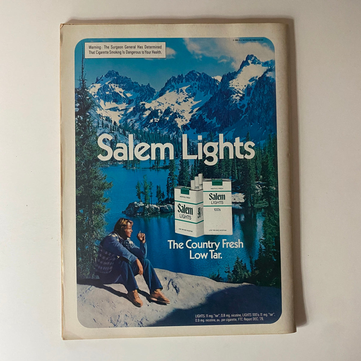 Vintage advertisement for Salem Lights cigarettes featuring a man sitting by a lake surrounded by mountains. The ad promotes 'The Country Fresh Low Tar' and includes a health warning. This image complements the TV Picture Life Magazine November issue featuring John Schneider and Valerie Bertinelli.