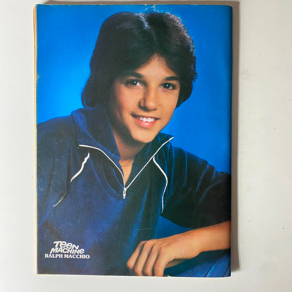 Ralph Macchio smiling in a navy outfit, featured in Teen Machine Magazine December 1981.