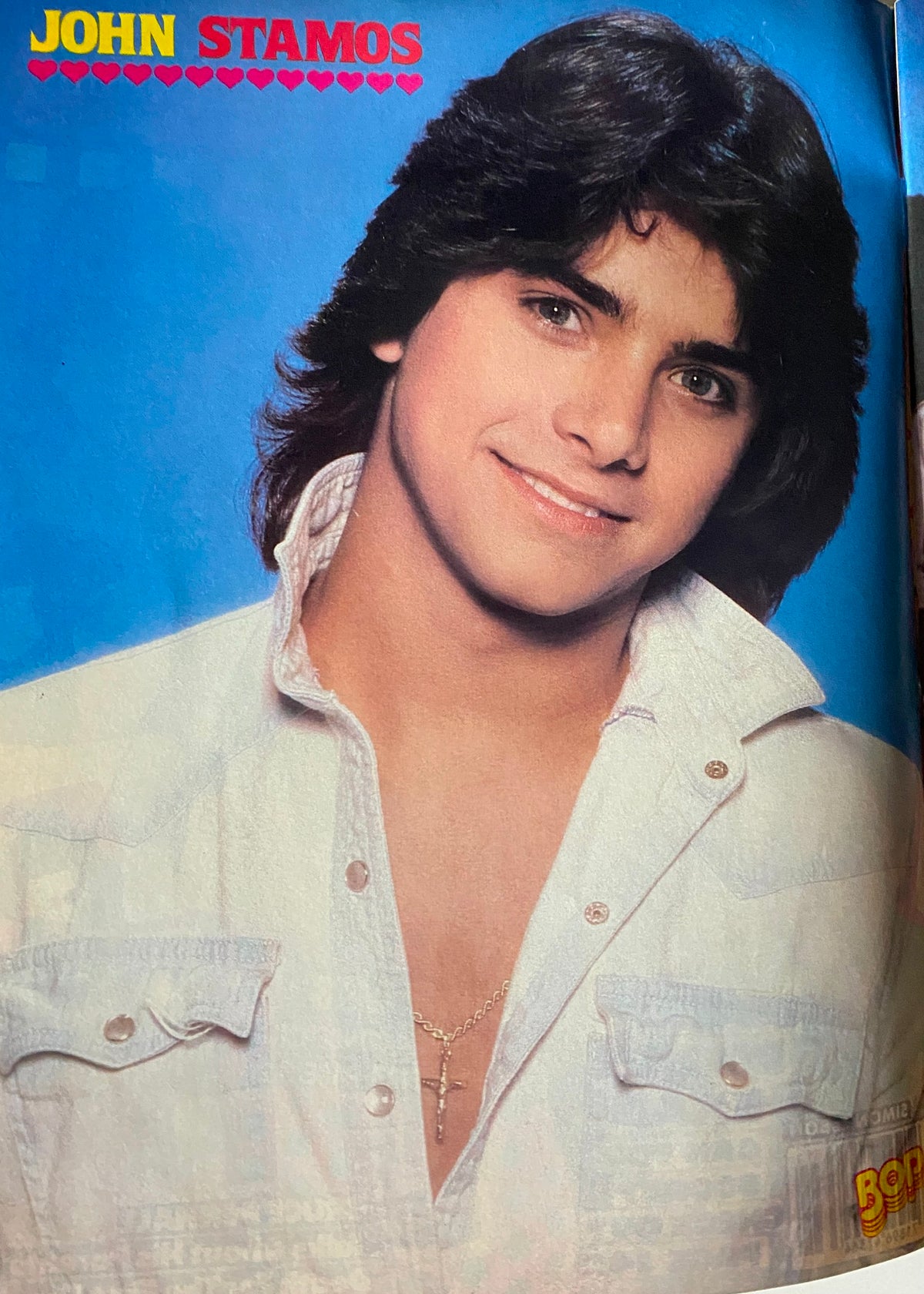 Full-page magazine feature of John Stamos from BOP Magazine November 1983 showcasing the teen idol's portrait.
