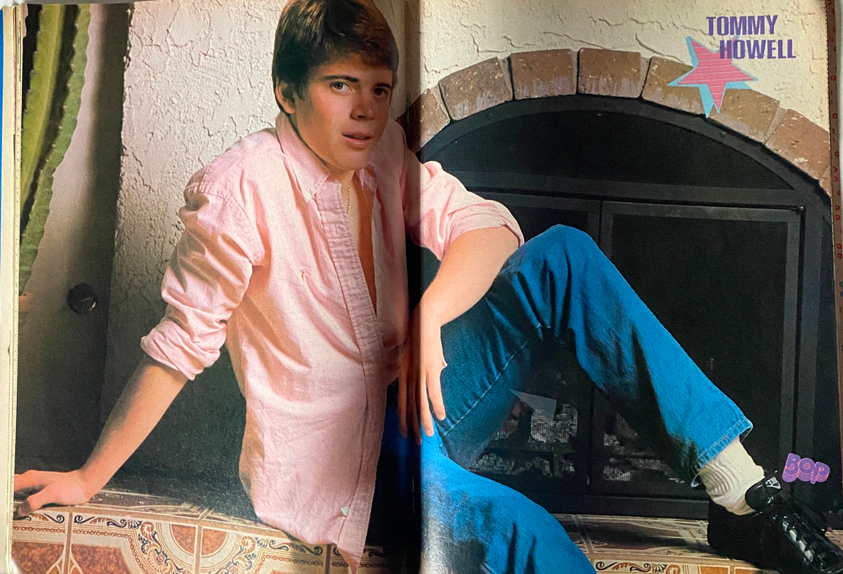 Tommy Howell featured in BOP Magazine November 1983, showcasing a stylish young man in a pink shirt and blue jeans, posed against a decorative wall and fireplace.