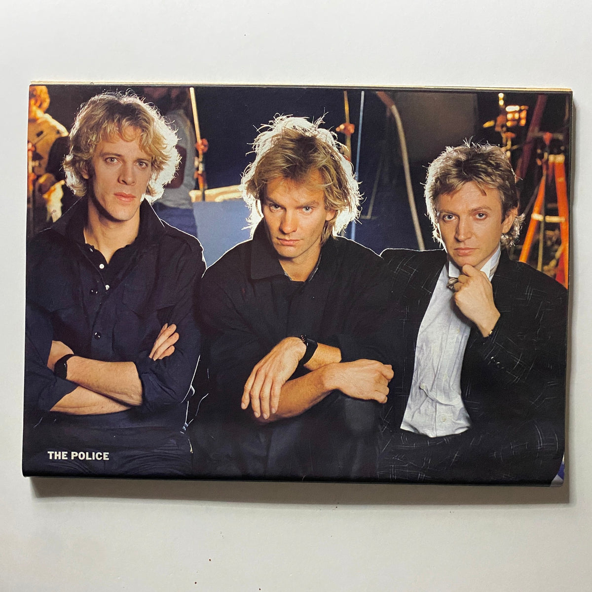 Promotional image of The Police featured in Rock Fever Magazine May 1984, showcasing the band's members in a classic 1980s rock pose.