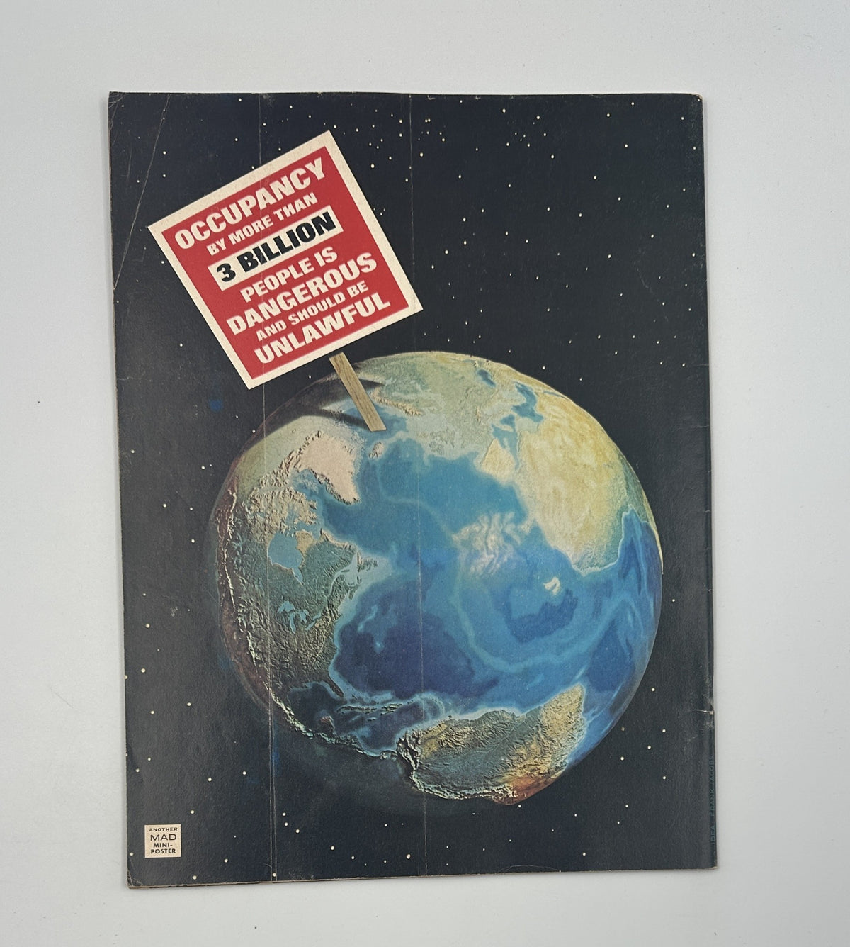 Back cover of MAD Magazine No. 176 July 1975 showing an image of Earth with a bold message about overcrowding, complementing the magazine's satirical take on current events.