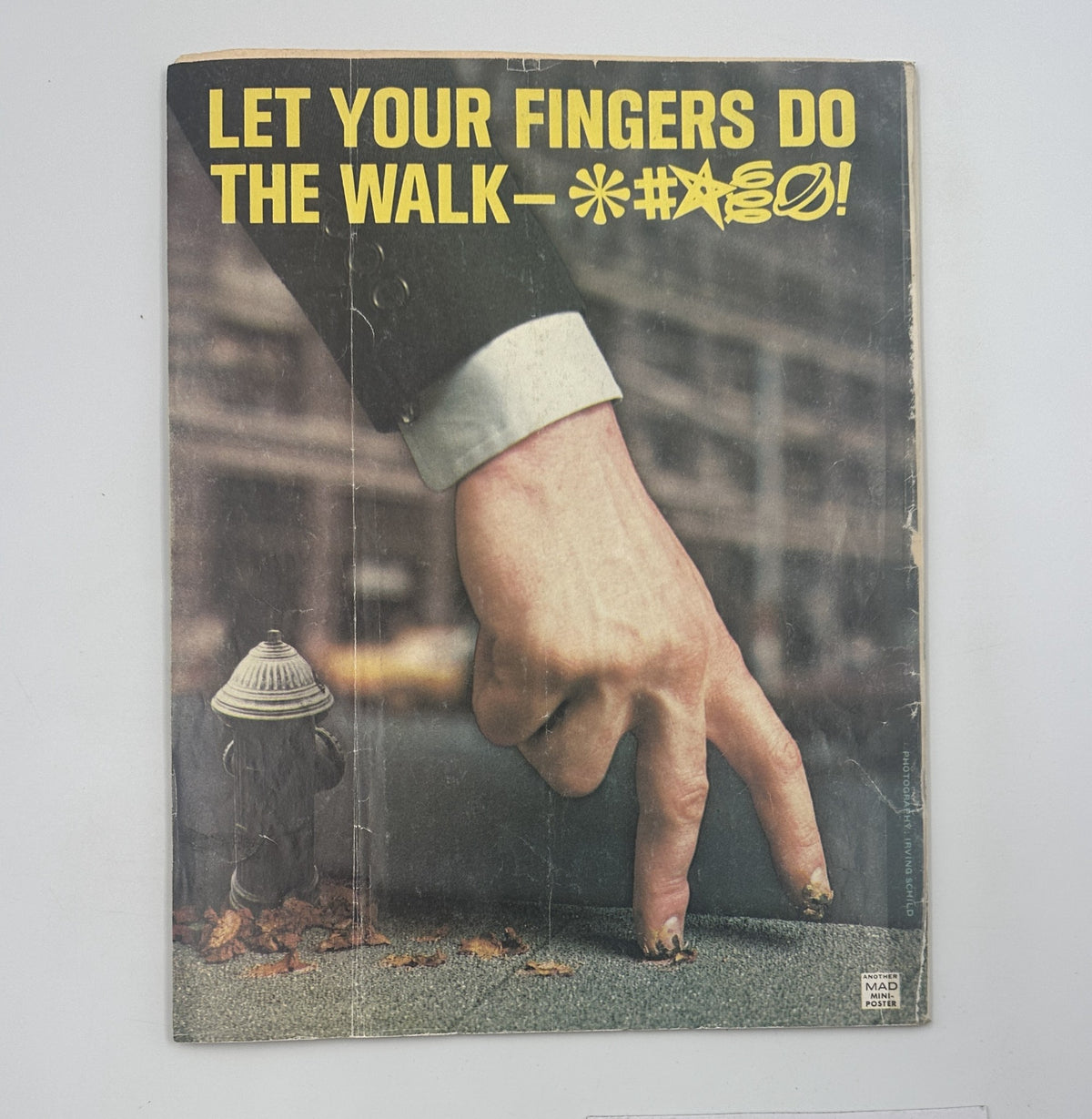 Back cover of MAD Magazine No. 184 from July 1976, with an eye-catching graphic of a hand manipulating the text, emphasizing classic MAD Magazine humor.