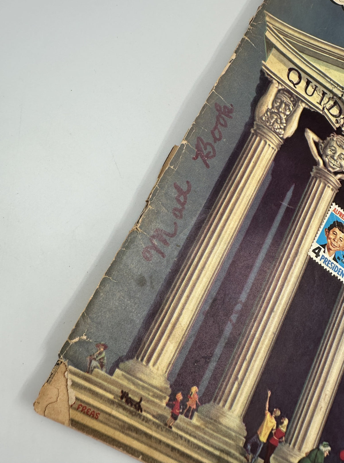 Close-up of the cover of MAD Magazine No. 65 September 1961, highlighting the title and illustrations along with a handwritten note that reads 'Mad Book.' The image reflects the magazine's humorous approach to travel.