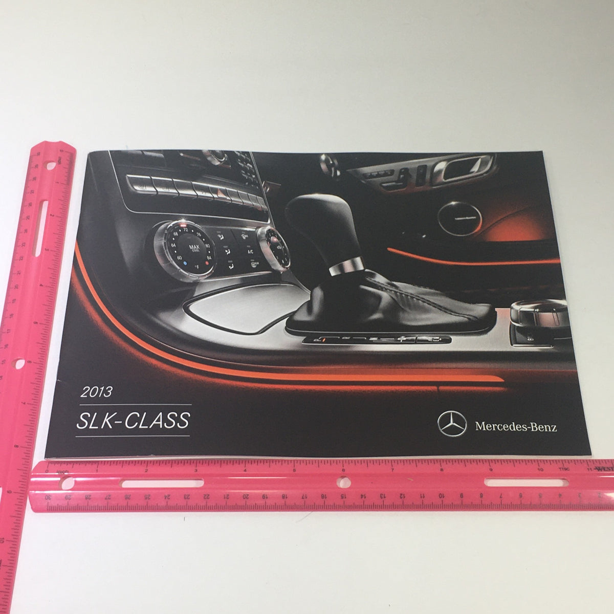 Front cover of the 2013 Mercedes-Benz SLK-Class Dealership Car Auto Brochure Catalog showcasing the interior gear shift and dashboard design.